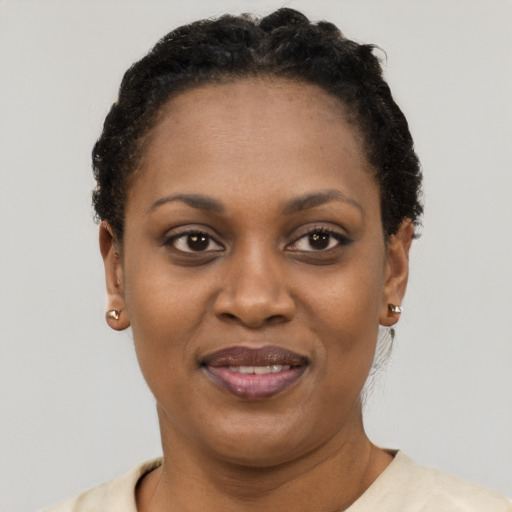 Joyful black young-adult female with short  black hair and brown eyes
