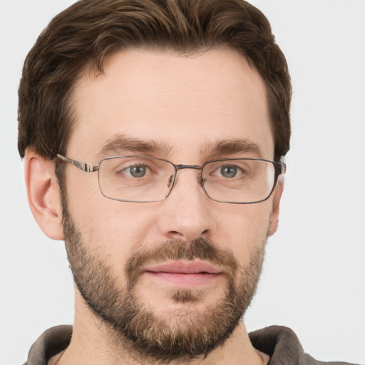 Joyful white adult male with short  brown hair and grey eyes