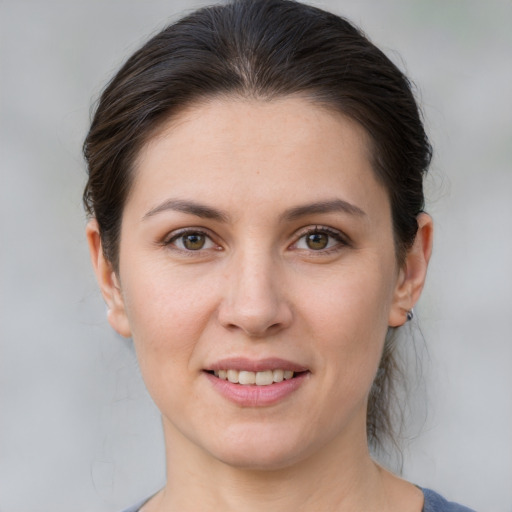 Joyful white young-adult female with medium  brown hair and brown eyes