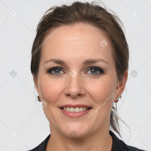 Joyful white adult female with medium  brown hair and grey eyes