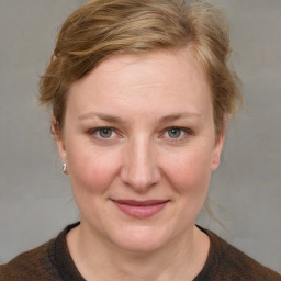 Joyful white adult female with medium  brown hair and blue eyes