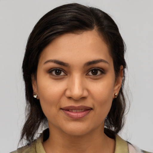 Joyful latino young-adult female with medium  brown hair and brown eyes
