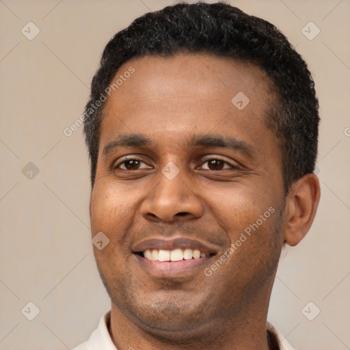 Joyful latino young-adult male with short  black hair and brown eyes