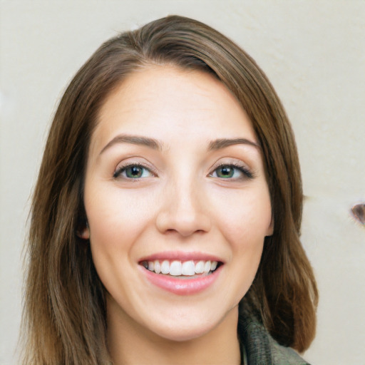 Joyful white young-adult female with long  brown hair and green eyes