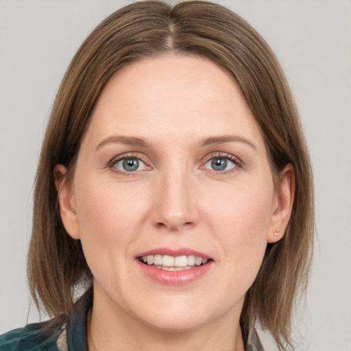 Joyful white young-adult female with medium  brown hair and grey eyes