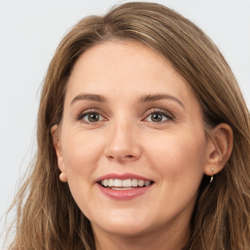 Joyful white young-adult female with long  brown hair and grey eyes