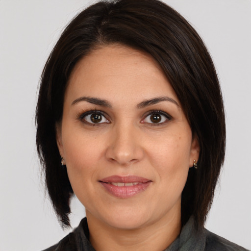 Joyful white adult female with medium  brown hair and brown eyes