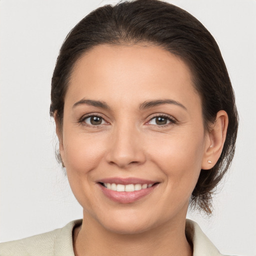 Joyful white young-adult female with medium  brown hair and brown eyes