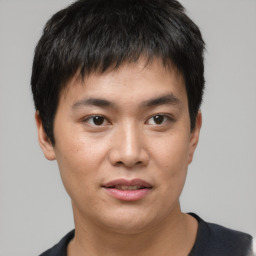 Joyful asian young-adult male with short  brown hair and brown eyes