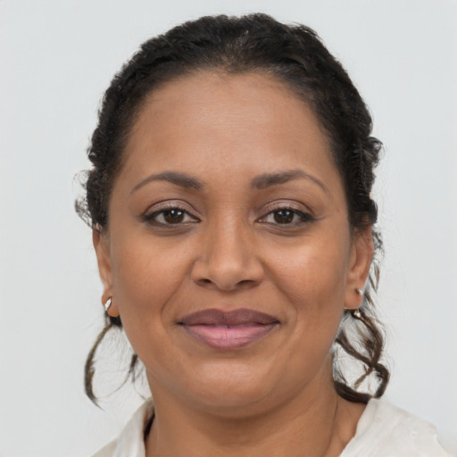 Joyful latino adult female with medium  brown hair and brown eyes