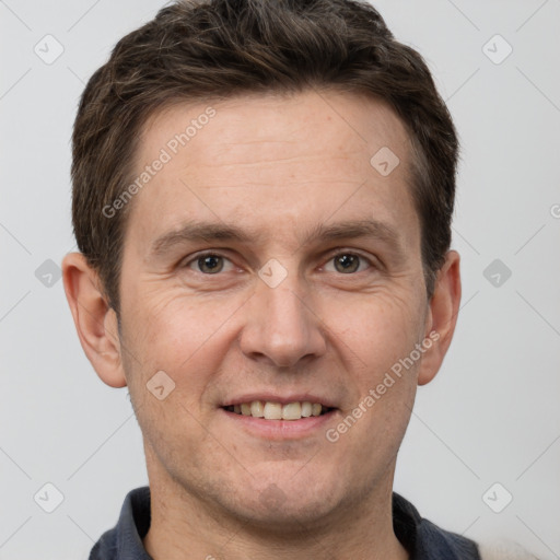 Joyful white adult male with short  brown hair and grey eyes