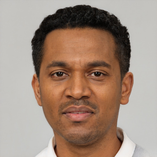 Neutral latino adult male with short  black hair and brown eyes