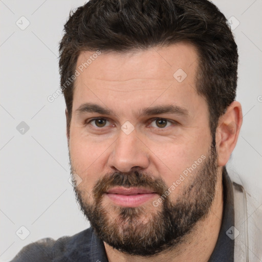 Joyful white adult male with short  brown hair and brown eyes