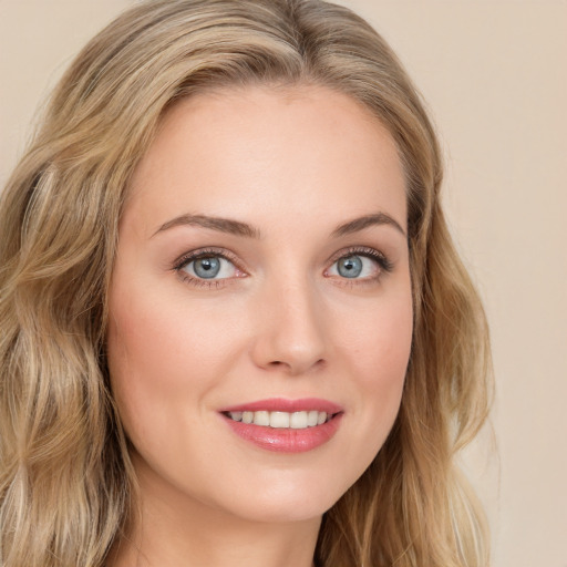 Joyful white young-adult female with long  brown hair and blue eyes