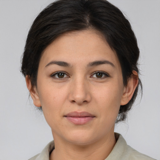 Joyful asian young-adult female with medium  brown hair and brown eyes