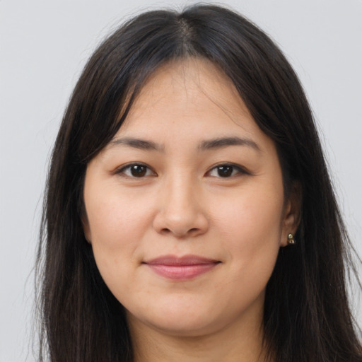 Joyful latino young-adult female with long  brown hair and brown eyes