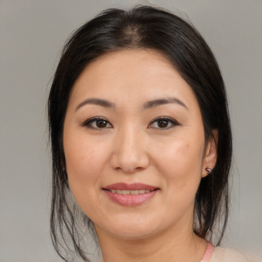 Joyful white young-adult female with medium  brown hair and brown eyes