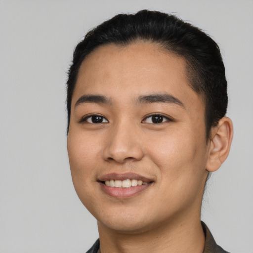 Joyful latino young-adult male with short  black hair and brown eyes