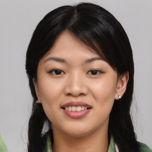 Joyful asian young-adult female with medium  black hair and brown eyes
