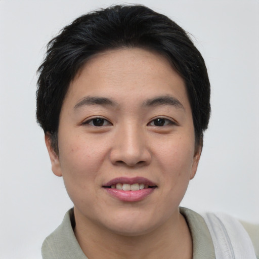 Joyful asian young-adult female with short  black hair and brown eyes