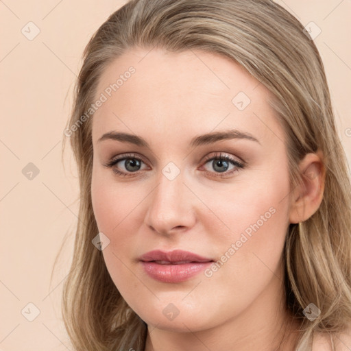 Joyful white young-adult female with long  brown hair and grey eyes