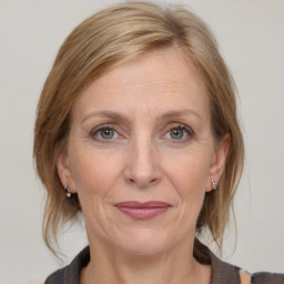 Joyful white adult female with medium  brown hair and grey eyes