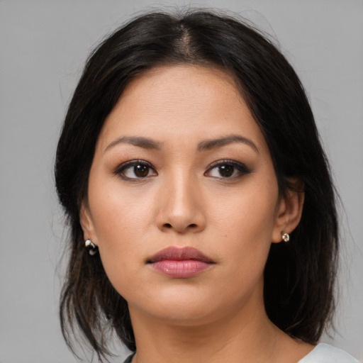 Neutral asian young-adult female with medium  brown hair and brown eyes