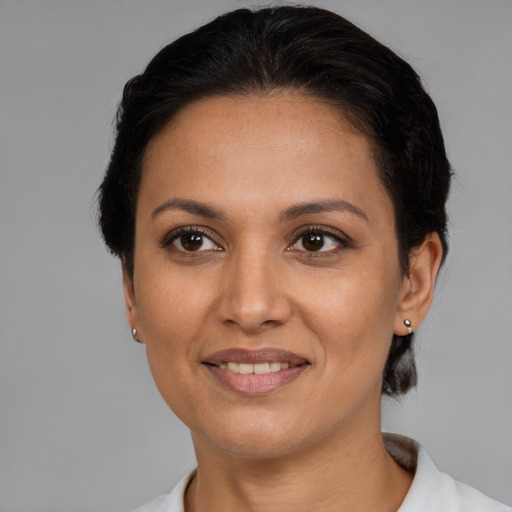 Joyful latino adult female with short  brown hair and brown eyes