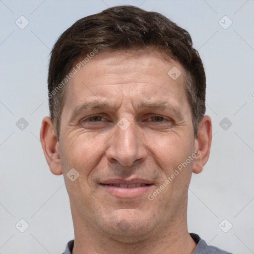 Joyful white adult male with short  brown hair and grey eyes