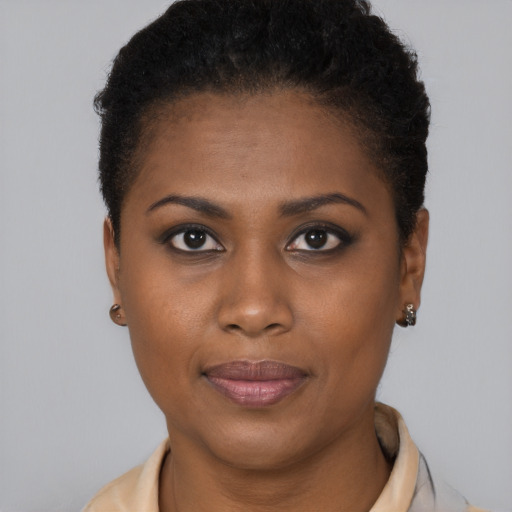 Joyful black young-adult female with short  brown hair and brown eyes