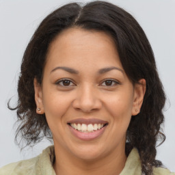 Joyful latino adult female with medium  brown hair and brown eyes