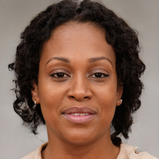 Joyful black adult female with medium  brown hair and brown eyes