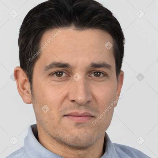 Joyful white adult male with short  brown hair and brown eyes