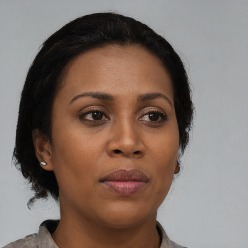 Joyful black young-adult female with short  brown hair and brown eyes