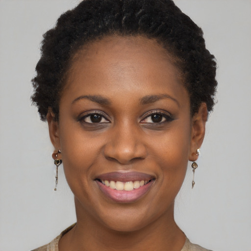 Joyful black young-adult female with short  brown hair and brown eyes