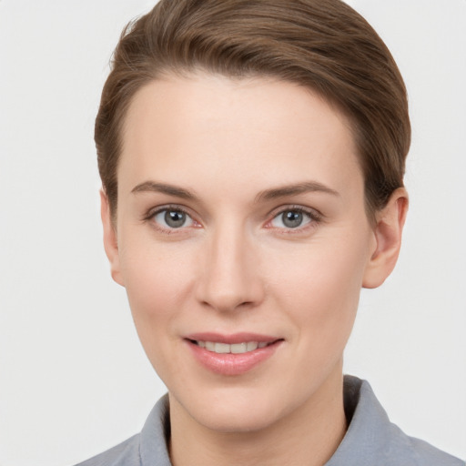 Joyful white young-adult female with short  brown hair and grey eyes