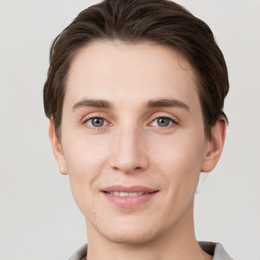 Joyful white young-adult male with short  brown hair and grey eyes