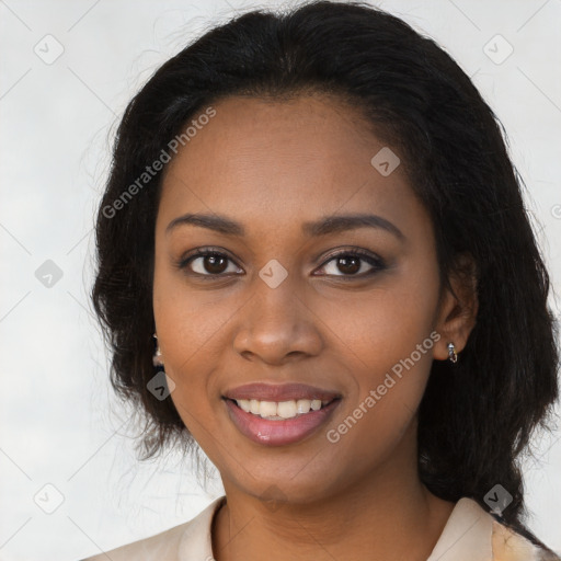 Joyful black young-adult female with long  brown hair and brown eyes