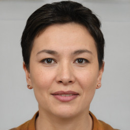 Joyful white adult female with short  brown hair and brown eyes