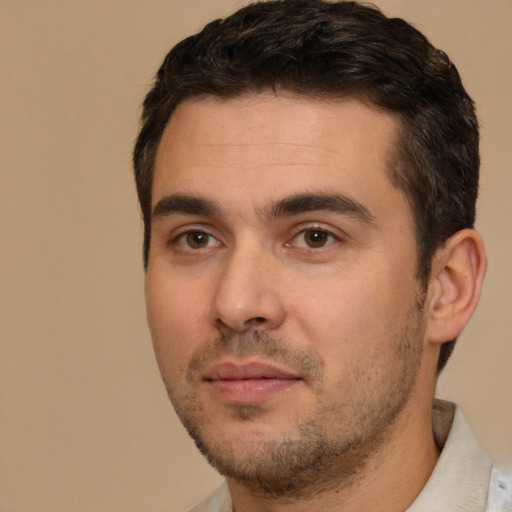 Joyful white young-adult male with short  brown hair and brown eyes