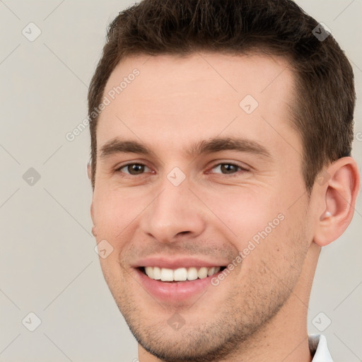 Joyful white young-adult male with short  brown hair and brown eyes