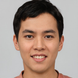 Joyful asian young-adult male with short  black hair and brown eyes