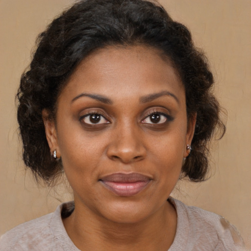 Joyful latino adult female with medium  brown hair and brown eyes