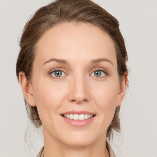 Joyful white young-adult female with medium  brown hair and grey eyes