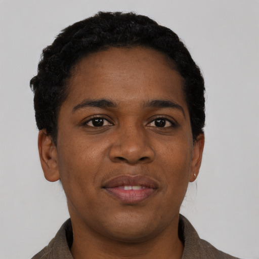 Joyful black young-adult female with short  black hair and brown eyes
