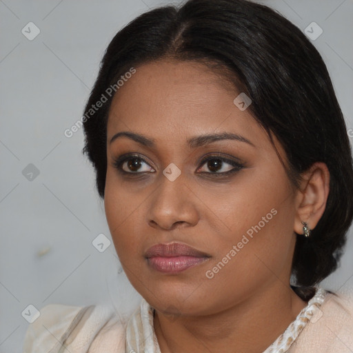 Joyful black young-adult female with medium  brown hair and brown eyes