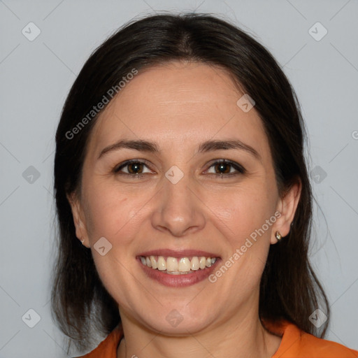 Joyful white adult female with medium  brown hair and brown eyes