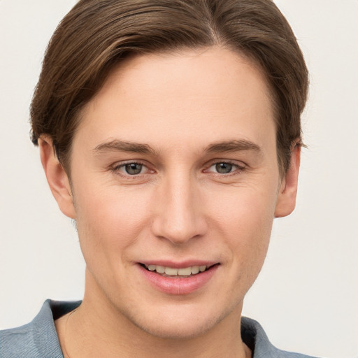 Joyful white young-adult female with short  brown hair and grey eyes