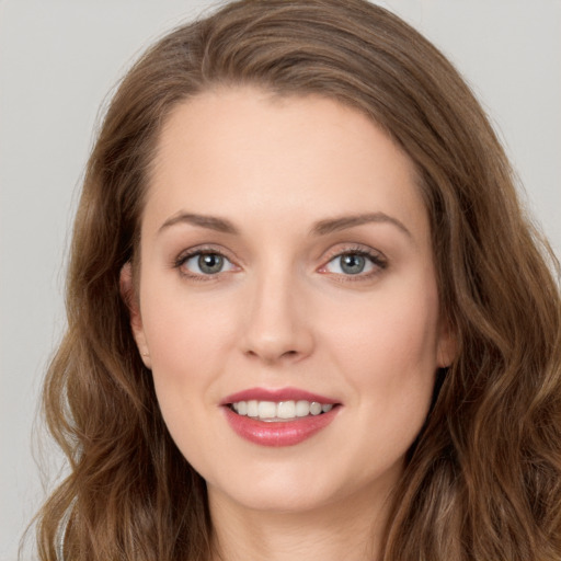 Joyful white young-adult female with long  brown hair and green eyes