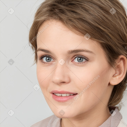 Joyful white young-adult female with medium  brown hair and blue eyes